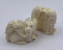 A Pair of carved netsukes one elephant and one dragon