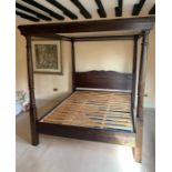 A stained pine four poster bed with slatted frame base