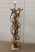 A floor standing lamp made of twisted wood