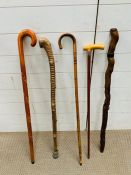 A selection of vintage walking sticks including a silver collared walking cane