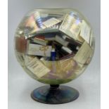 A large collection of matchboxes in a fishbowl shaped vase