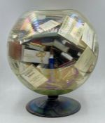 A large collection of matchboxes in a fishbowl shaped vase