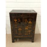 A japanned cabinet with two doors and shelve inside (H80cm W59cm D38cm)