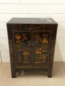 A japanned cabinet with two doors and shelve inside (H80cm W59cm D38cm)