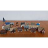 A collection of seventeen collectable miniature ceramic and pottery hand painted houses, made in