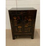 A japanned cabinet with two doors and shelve inside (H80cm W59cm D38cm)