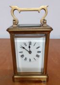 A brass and glass skeleton carriage clock, (10.5x8x6.5 cm).