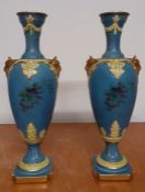 A pair of Neoclassical style baluster shaped urns with rams heads handles, marked with the company