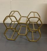 A gold effect hexagon wine rack