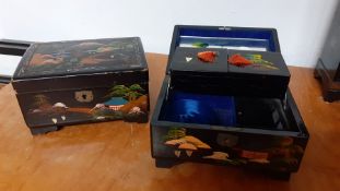 A pair of Chinese black lacquered jewellery boxes, fitted interior with mirror, (10x18x13 cm ). (2)