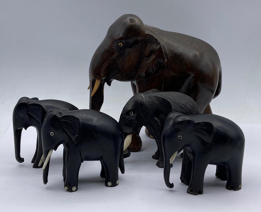 Four carved elephant figures