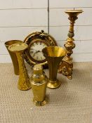 Six gold coloured decorative objects including a clock.