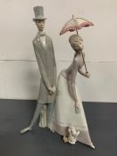 A Lladro figure of a Gentleman and Lady holding an umbrella (50 cm High)