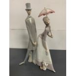 A Lladro figure of a Gentleman and Lady holding an umbrella (50 cm High)