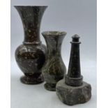 A collection of three carved serpentine items including two small vases and a lighthouse