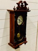 A mahogany wall hanging clock