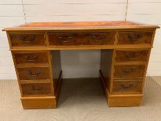 A pedestal desk with oxblood red leather top AF