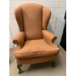 A wing back chair on mahogany cabriole legs