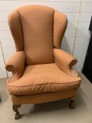 A wing back chair on mahogany cabriole legs