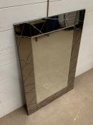 A smoked glass edged wall mirror (60cm x 90cm)