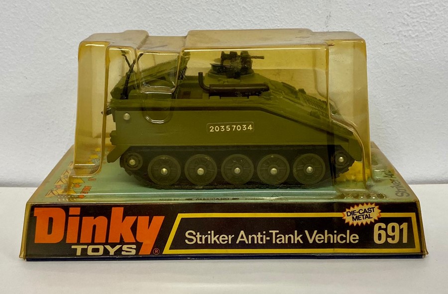 A boxed Dinky 691 Striker Anti-Tank Vehicle with shells