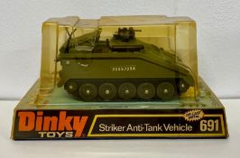 A boxed Dinky 691 Striker Anti-Tank Vehicle with shells