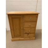 A pine tall boy style cabinet with long door to side and drawers to other (H84cm W74cm D33cm)