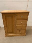 A pine tall boy style cabinet with long door to side and drawers to other (H84cm W74cm D33cm)