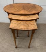 A walnut nest of table, three nesting tables on pad feet (Largest H52cm W60cm D42cm)