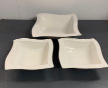 Three white china serving dishes