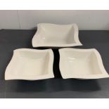 Three white china serving dishes