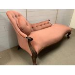 A chaise lounge with pink velvet upholstery and mahogany turned legs (H90cm W172cm D77cm)