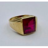 A 10k gold signet ring with red coloured glass stone (Total Weight 7g) Size S