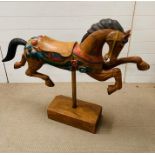 A carved display horse on plinth (H89cm W110cm)
