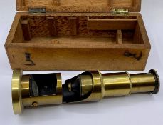 A brass microscope, cased