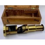 A brass microscope, cased