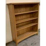 A pine free standing bookcase or shelving unit (H126cm W108cm D34cm)