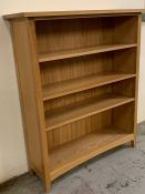 A pine free standing bookcase or shelving unit (H126cm W108cm D34cm)