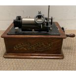 An Edison Standard phonograph, black japanned metal in oak case.