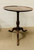 A George III style tilt top on down swept legs