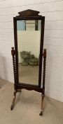 A floor standing oak mirror with barley twist supports (H163cm W49cm)