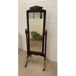 A floor standing oak mirror with barley twist supports (H163cm W49cm)