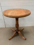 A circular side table on four spade feet (H68cm Dia55cm)