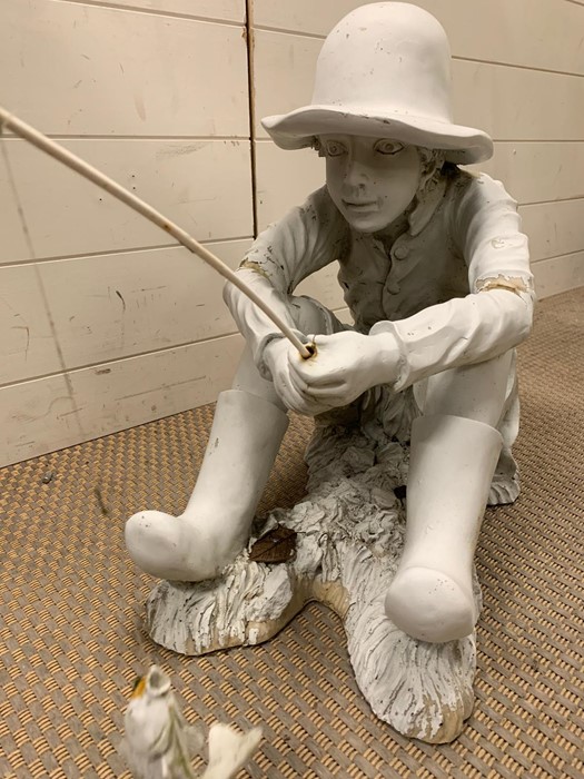 A garden plaster model of a child fishing (H46cm W40cm)