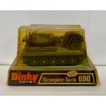 A boxed Dinky 690 Scorpion tank with shells and camouflage nets