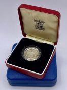 A Silver proof Royal Mint £1 coin and a Silver proof 1977 Jubilee crown.