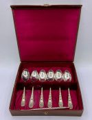 A Boxed set of six decorative teaspoons and two snail picks.