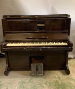An upright self playing piano by J Hopkins and Sons Grimsby with a selection of music rolls (
