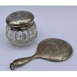 A small silver backed hand mirror and dressing table pot with hallmarked silver top.