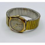 A 9ct gold Hirco watch on stainless steel strap.